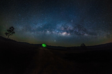Wall Mural - the milky way galaxy on the meadow, on the mountain at dawn long exposure photograph, with grain.ima