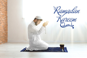 Wall Mural - Praying Muslim man at home. Ramadan celebration