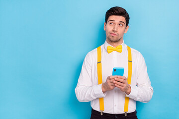 Sticker - Portrait of serious minded man look interested empty space brainstorming isolated on blue color background