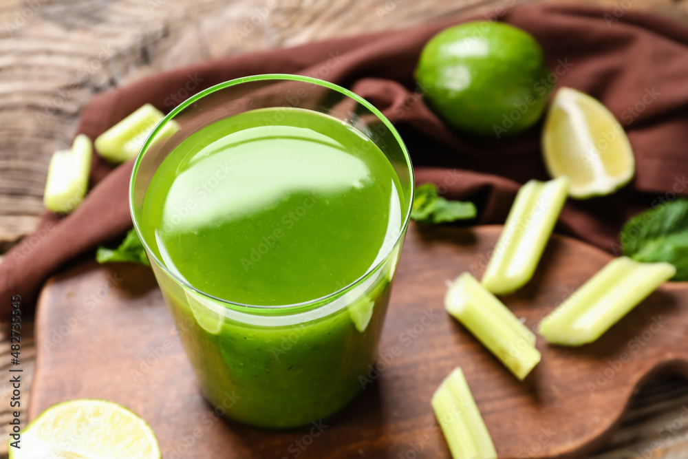 Glass of healthy green juice on table
