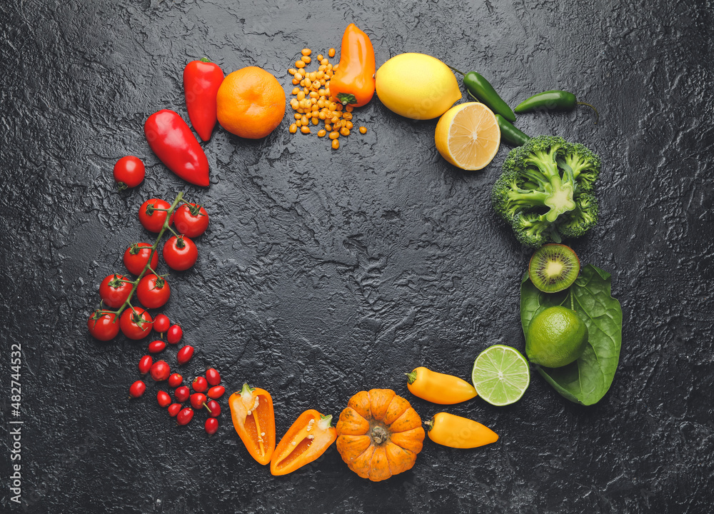 Frame made of different healthy products on dark background