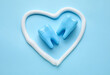 Heart drawn with toothpaste and teeth on blue background