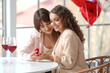 © Pixel-Shot - Young lesbian woman proposing to her girlfriend at home