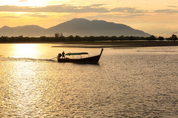 Wall Mural - Sunrise from a longtail boat off the coast of Ranong Province, Thailand.