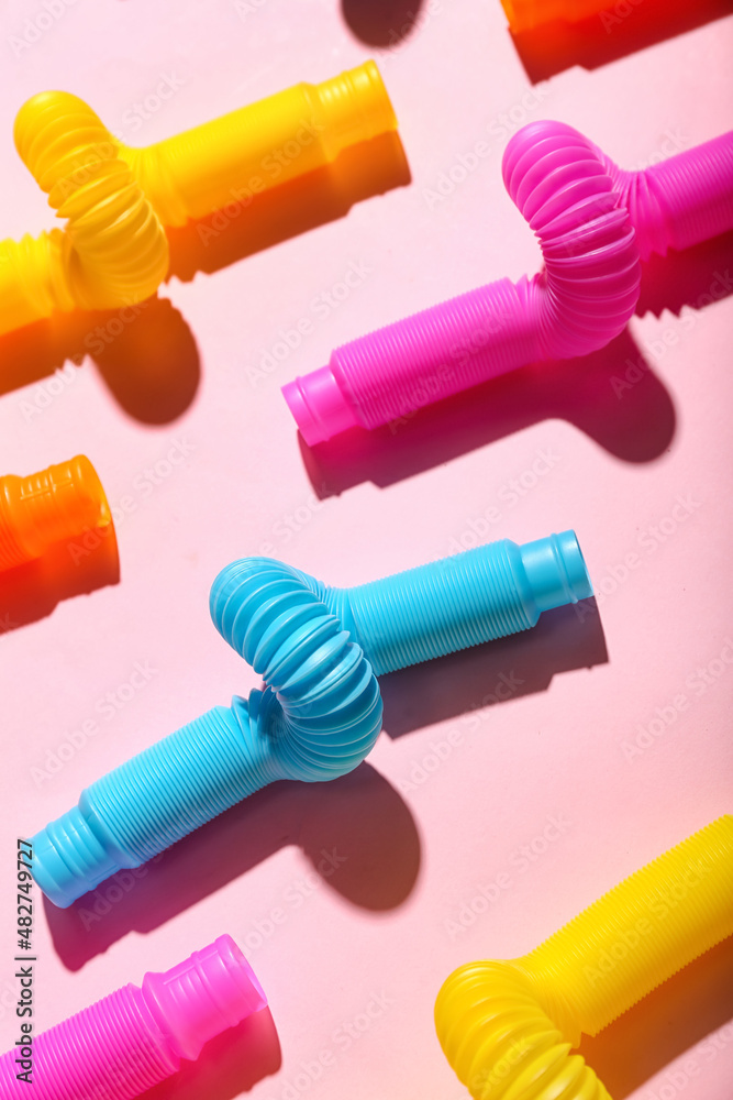 Pop Tubes on pink background