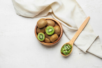 Wall Mural - Bowl with fresh kiwi on light background