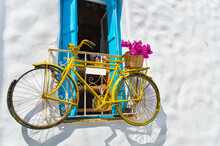 Decorative Bicycle Hanging From A Window In A Greek House On Naxos Island, Greece