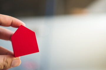 Poster - Wooden red miniature home in hand