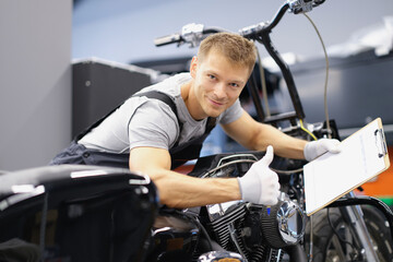 Wall Mural - Car maintenance service male show thumbs up and happily smile with clipboard