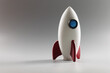 © H_Ko - Miniature rocket toy stand on surface, rocketship as symbol for business project and startup