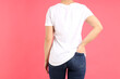 © Atlas - Woman in blank white t-shirt on pink background