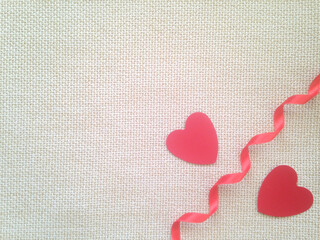 Composition of two red hearts with red ribbon on white background. Lovely valentine day, 14th February. Feeling in love, happy  life. Feel catch and grab by love. Space for text