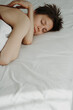 © anna - portrait of a girl under the morning sun on a white bed