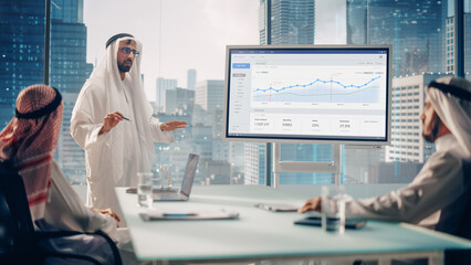 Wall Mural - Emirati Businessman Holds Meeting Presentation for International Business Partners. Manager Uses Whiteboard with Growth Analysis, Charts, Statistics and Data. Saudi, Emirati, Arab Office Concept.