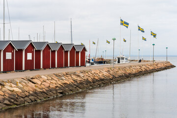 Typical Swedish west coastal environment with red boathouses, bridges and happy summer guests enjoying their vacation.