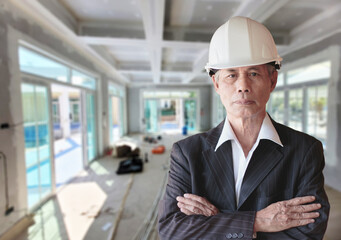 Wall Mural - Senior Asian businessman wearing a helmet