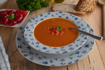 Wall Mural - Traditional red bell pepper soup on rustic deep plate 