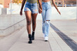 © Raul Mellado - legs of two young women strolling holding hands