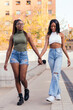 © Raul Mellado - young black female couple strolling holding hands