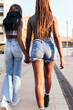 © Raul Mellado - rear view of an african female couple strolling