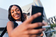 © Raul Mellado - african girl smiles taking a selfie with her phone