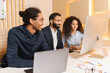 © Face Stock - Lively team holding meeting with boss via video link in modern office. Teleconference meeting using computer. Businessman having video call with his business team online, talking about strategy