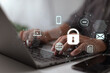 © ipuwadol - Cybersecurity on the internet, a user writing a password on a computer, and cyber security.