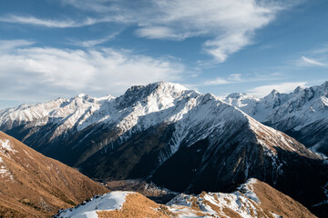 Wall Mural - Snowy Greater Caucasus ridge. Sunny day. Before suset. View from 3500m