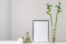 Floral Card Or Poster Mockup Or Silver Photo Frame With Bamboo Plant In Glass Vase,  Decorative Buddha Statuette And Candles