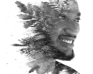 A double exposure portrait of a man combined with digital art.