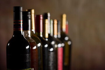 Wall Mural - Wine bottles collection on a dark background with copy space