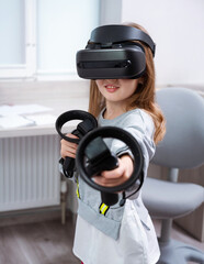 Wall Mural - girl 7 y.o. experiencing vr headset game at home. virtual technology simulator. emotional kid explor