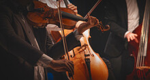 Musicians Play Violins And Cellos At A Concert.