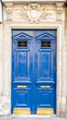 Paris, a blue wooden door, typical building in the center

