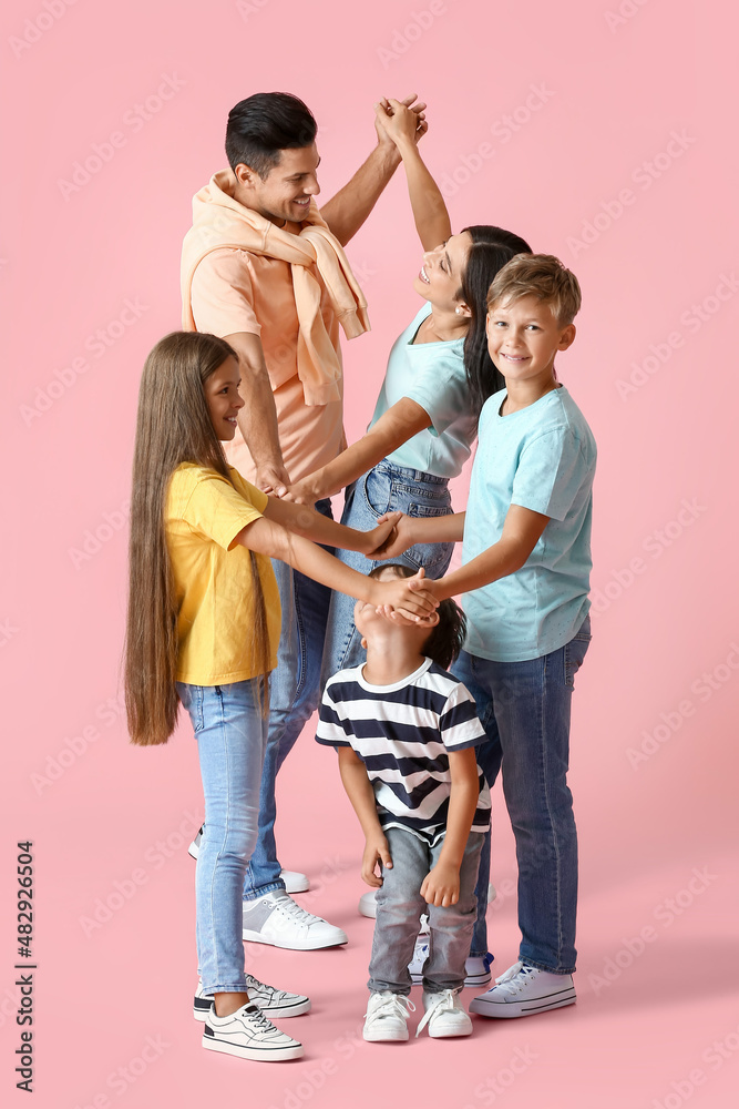 Happy dancing family on color background