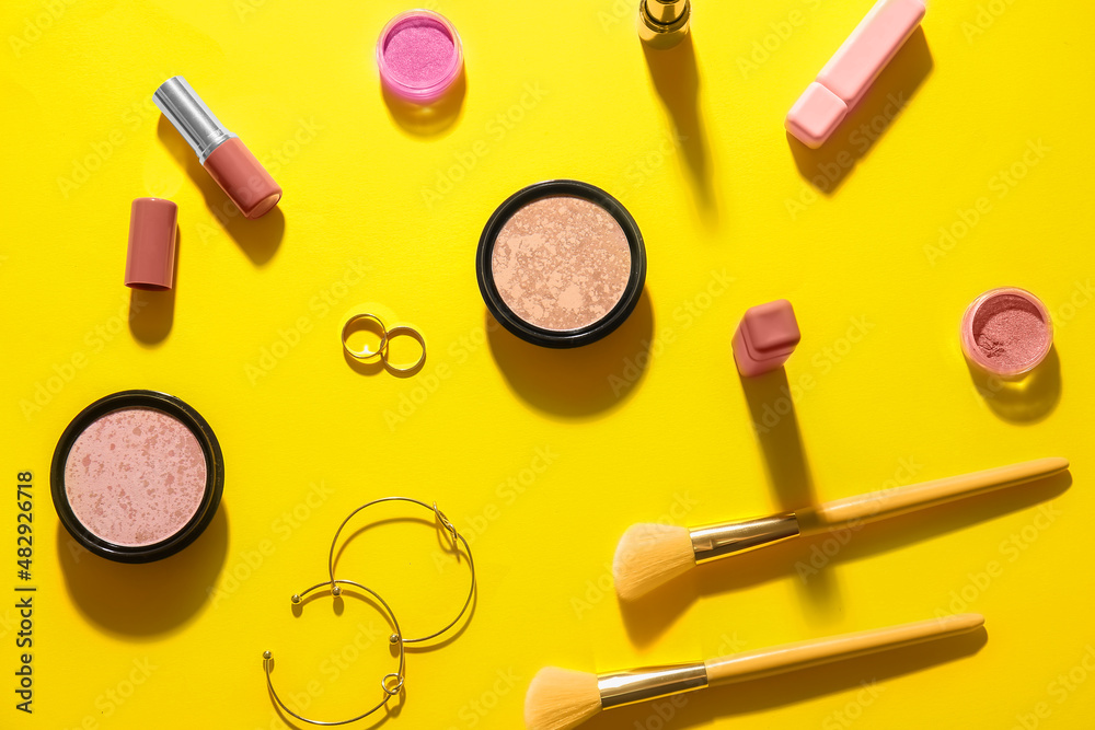 Decorative cosmetics on yellow background