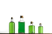 Several Glass Transparent Bottles With Cork Stopper On A Shelf. Vintage Glass Bottles With  Poisons On A White Background.