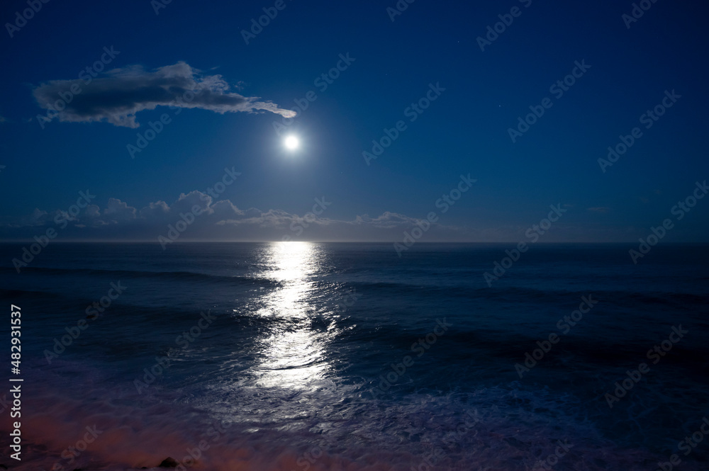 Moonlight path on water of Atlantic ocean at night on Tenerife and dark ...
