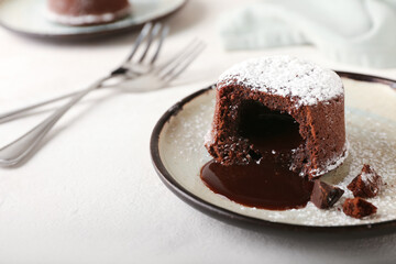 Plate with tasty lava cake fondant on white background, closeup