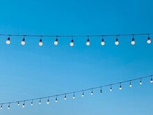 String Wired Bulbs On Evening Blue Sky