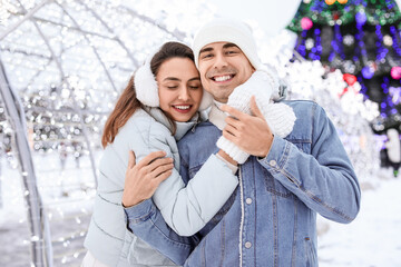 Poster - Pair of sweethearts hugging on snowy winter day