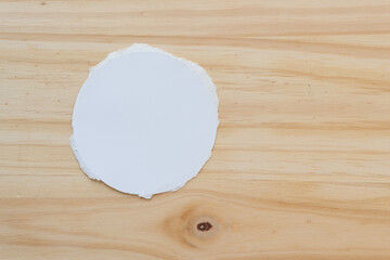 Wall Mural - paper circle on a wooden surface