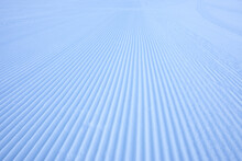 Fresh Snowfall After The Groomers Have Finished Rolling The Ski Slopes, Pattern And Texture In A Natural Cold White Snow Background
