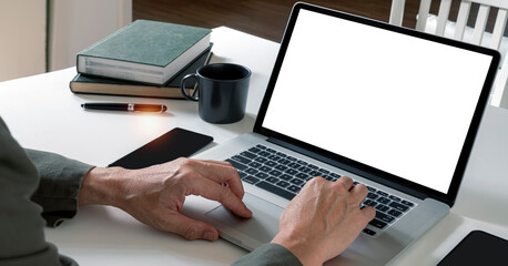 Fototapete - Man using laptop computer at home, mockup blank screen for product display.