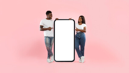 Couple showing blank empty screen for mock up