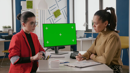 Poster - business women doing teamwork on computer with green screen, working with mock up copy space on isol