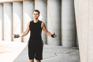 Poster - caucasian man fighter training hard in the outdoors.. Man using rope, making warm up. concept about sport and boxing