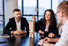 Businessmen Play Jenga. Business Holiday Concept. Young People Play Board Games In The Office