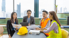 A Group Of Construction Engineers Or Real Estate Architectures From Different Genders And Cultures Have Meeting With Investor For A New Development Project In A Green Office With Cityscape Background