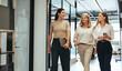 Leinwandbild Motiv Three businesswomen walking together in an office